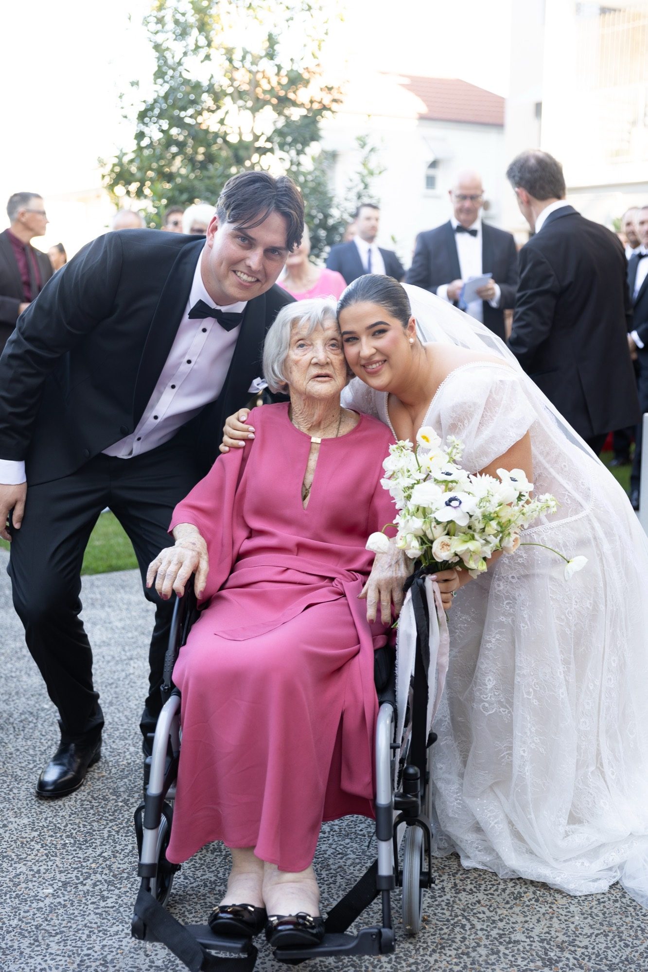 The couple with the bride's grandmother outside the church after the ceremony