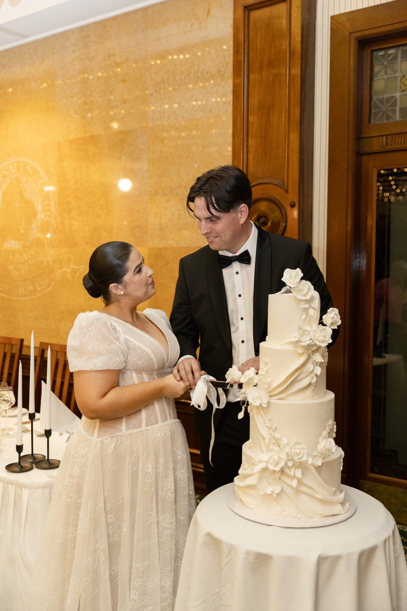 Cutting the wedding cake in the dining room at Tattersall's Club, Brisbane