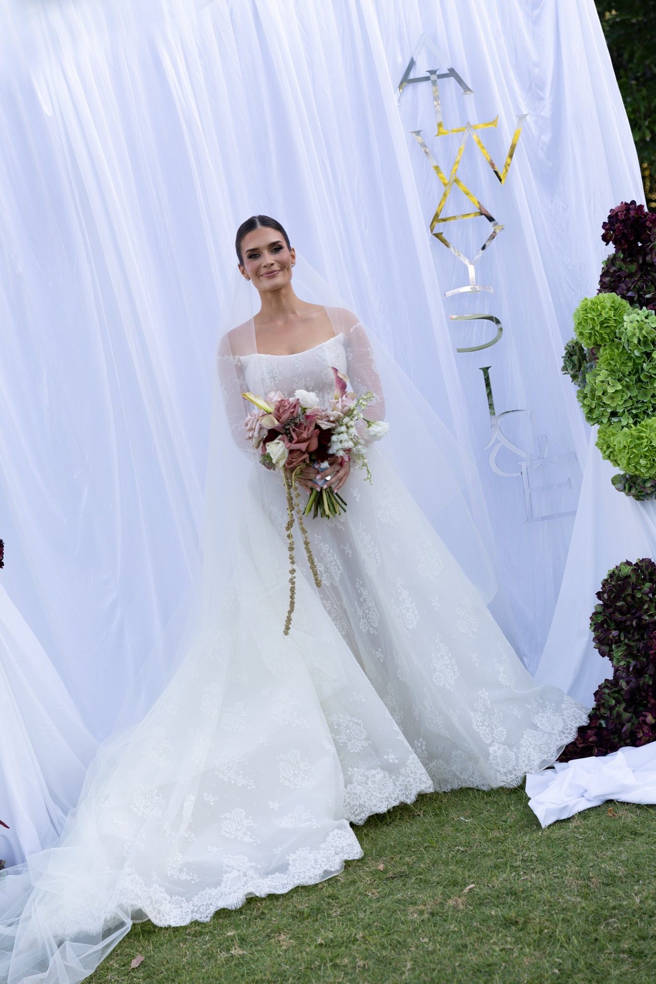 Bridal portrait before the white draped backdrop with the couple's monogram and hydrangea columns, Airlie Beach